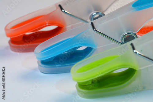 Closeup on three Colorful Plastic Clothespins