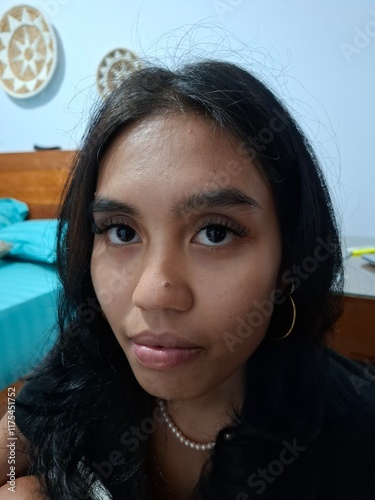 Confident Woman Posing Indoors in a Casual Setting 