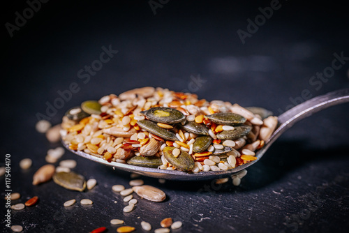 A vibrant close-up of a seed mix featuring pumpkin seeds, flaxseeds, sesame seeds, and sunflower seeds. The colorful textures highlight the variety and freshness of the seeds.