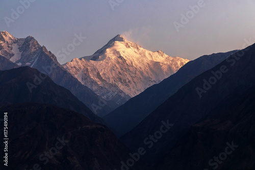 Obraz na plátně Majestic mountain peak bathed in sunrise glow