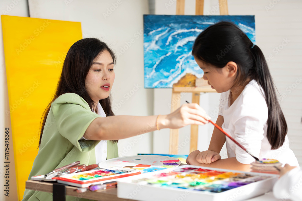 Fototapeta premium Children and Teacher drawing and filled with colorful paints in the classroom