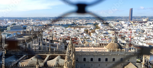 Spanish city landscape through wire fencing photo