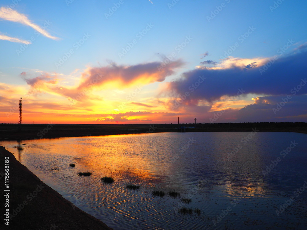 Fototapeta premium Reddish summer sunset over a lake in northern Spain