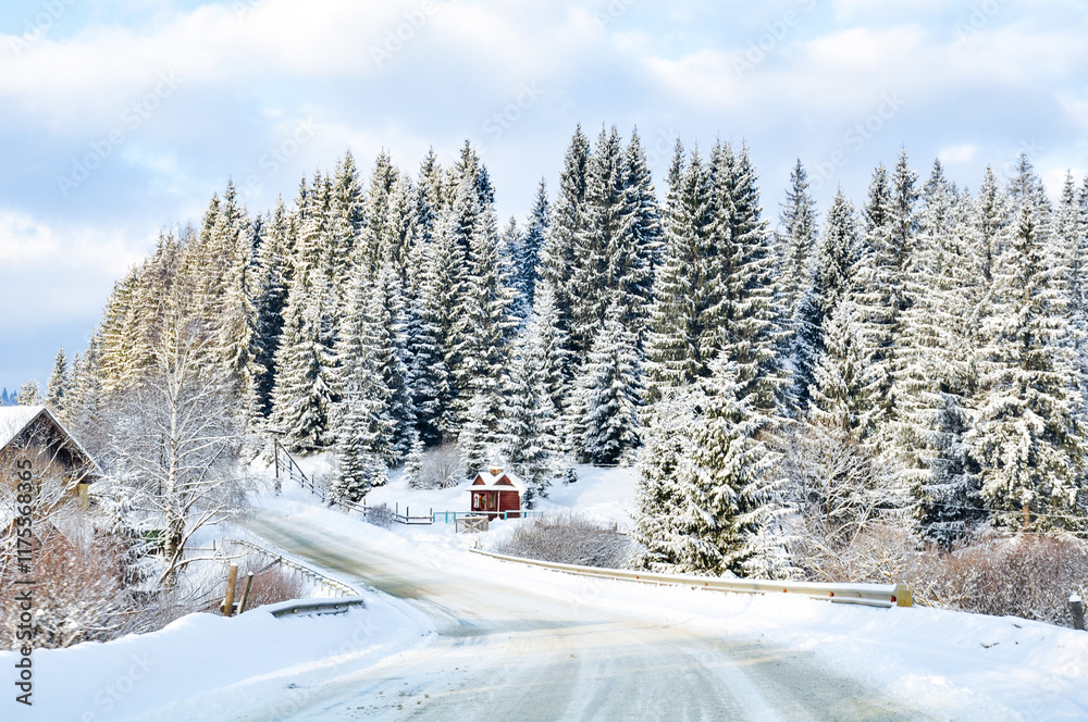 An empty winter road stretching through the countryside, bordered by a snow-covered coniferous forest. An empty winter road stretching through the countryside, bordered by a snow-covered coniferous forest.