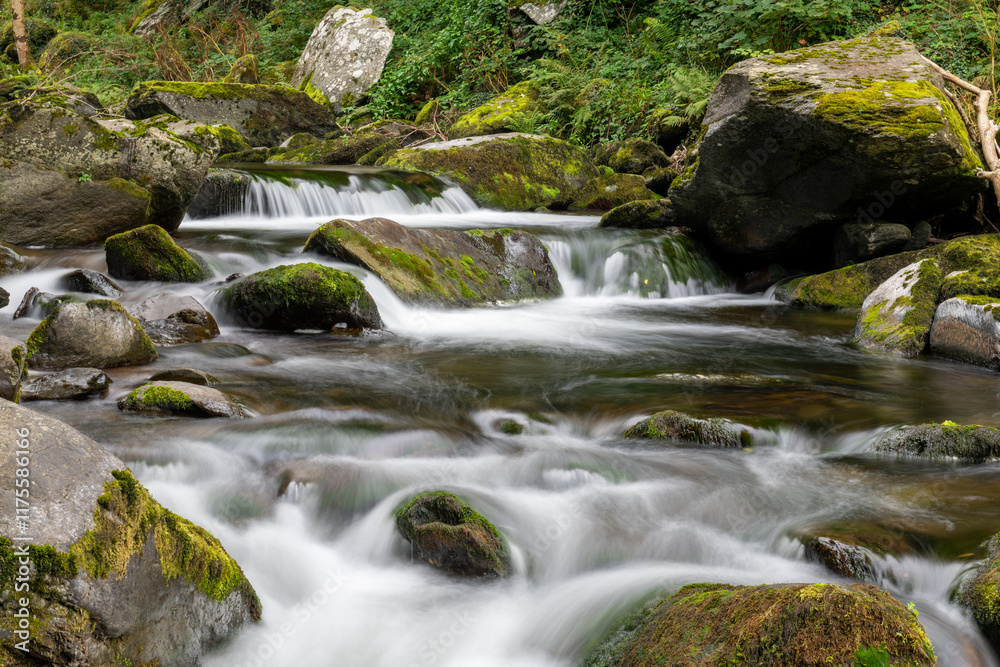 Long exposure of a waterfall on the East Lyn river at Watersmeet in Exmoor National Park Long exposure of a waterfall on the East Lyn river at Watersmeet in Exmoor National Park