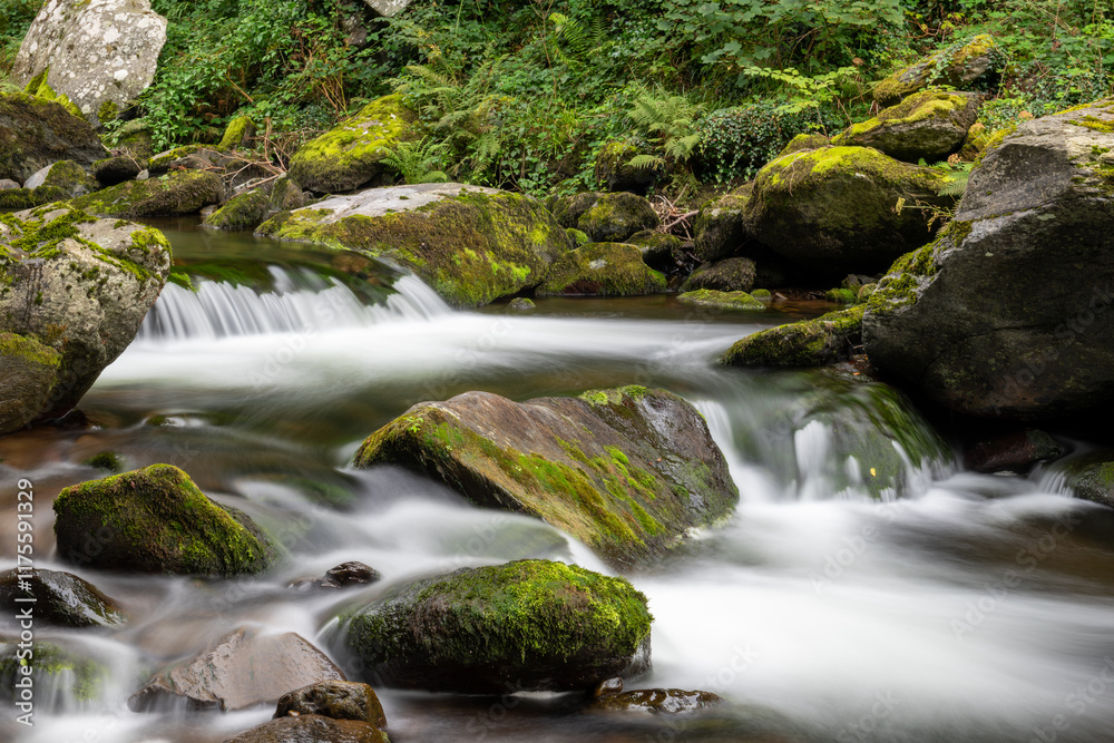 Long exposure of a waterfall on the East Lyn river at Watersmeet in Exmoor National Park Long exposure of a waterfall on the East Lyn river at Watersmeet in Exmoor National Park