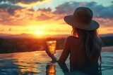 A woman, with a radiant smile, savors breathtaking sunset from an infinity pool, her hand delicately holding a cocktail, embodying epitome of luxury and relaxation, HD image