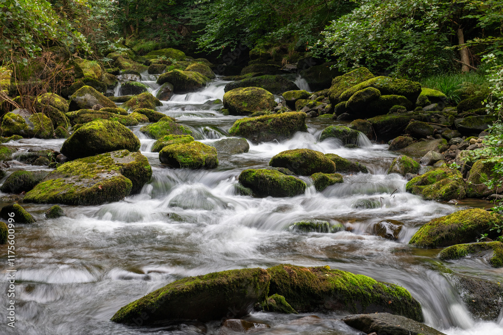 Long exposure of a waterfall on the East Lyn river at Watersmeet in Exmoor National Park Long exposure of a waterfall on the East Lyn river at Watersmeet in Exmoor National Park