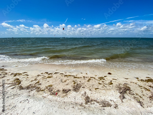 Kite surfing, beach and waves breaking on shore