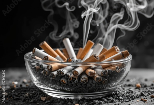 Smoked cigarettes in a glass ashtray photo