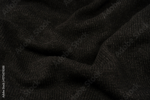 Dark grey sweater texture as a background. Knitted pattern. photo