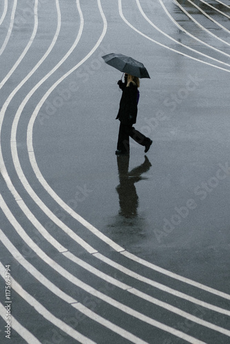 Canvas Print girl with umbrella walking at superkilen