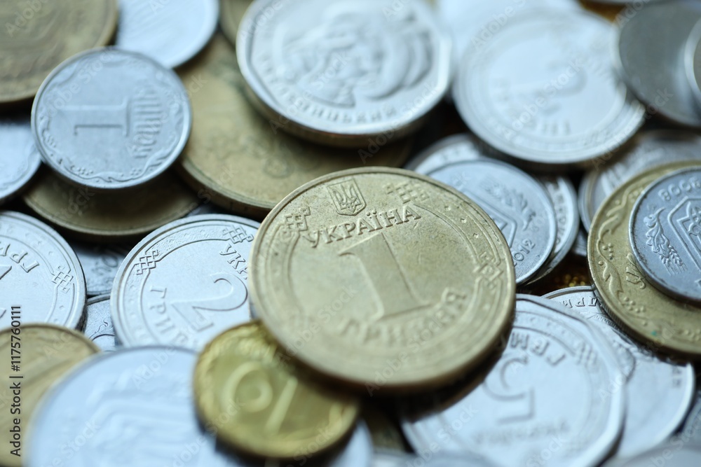 Metal coins of Ukraine of different denominations are scattered. Money texture, business background. Metal coins of Ukraine of different denominations are scattered. Money texture, business background.