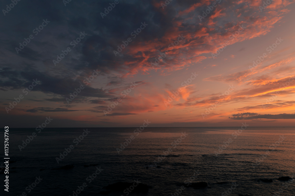 Obraz premium Sunset in the sea in orange tones, Sardinia