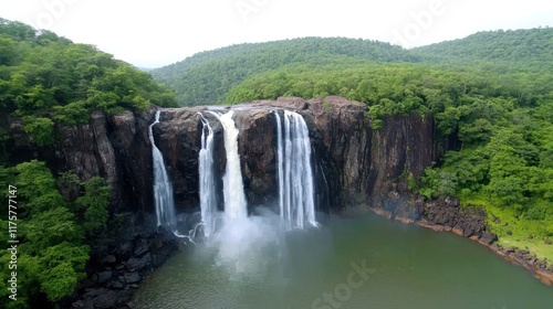 A scenic waterfall cascading into a tranquil pool surrounded by greenery.