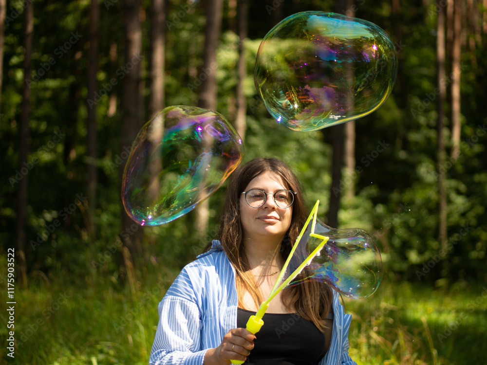 young girl blows beautiful and big soap bubbles young girl blows beautiful and big soap bubbles