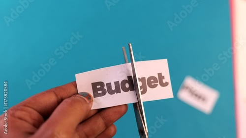 Cutting budget paper with siccor