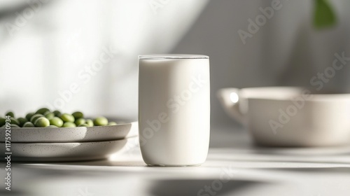 Wallpaper Mural Glass of milk on a white table. the glass is tall and slender with a handle on one side. it is filled to the brim with a creamy white liquid. Torontodigital.ca