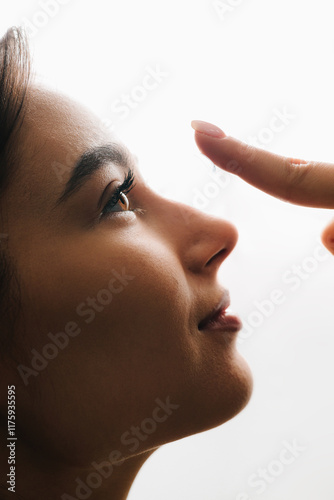 Myopia and astigmatism therapy with eye lenses chosen by ophthalmologist. Preparing contact lens before use for myopia treatment by woman. photo