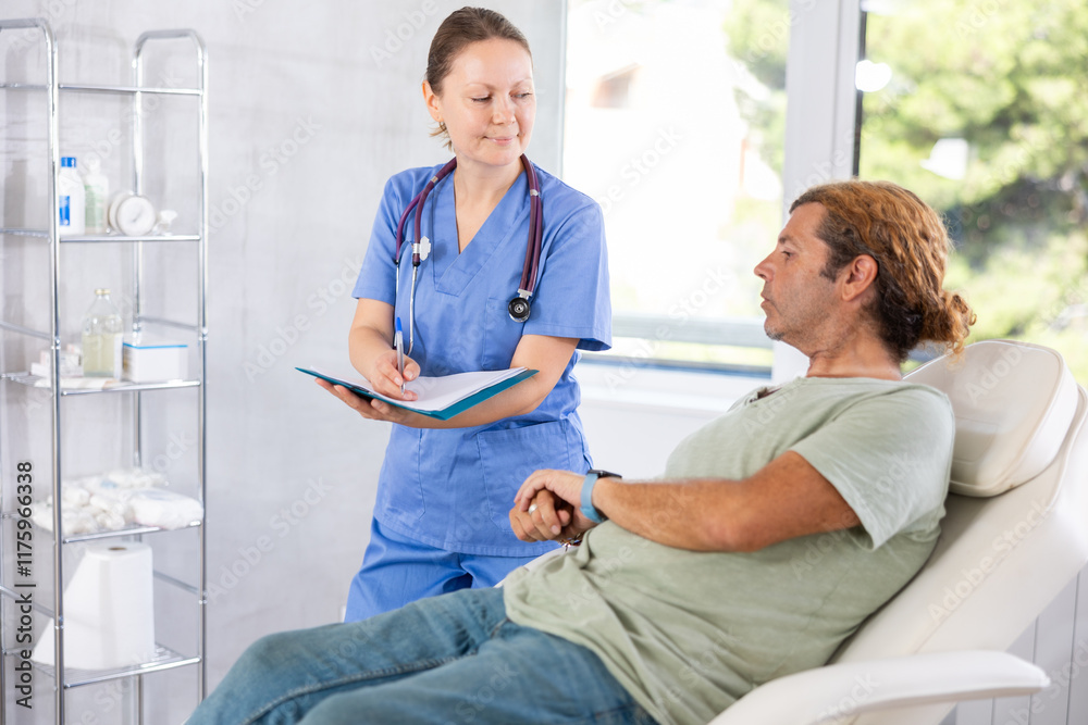 Fototapeta premium Adult female doctor in medical uniform signing contract with adult male patient in medical room