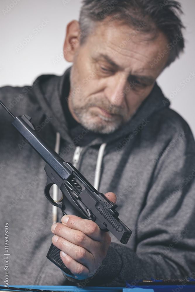 Man take care of small caliber semi automatic sporting gun .22 LR Man take care of small caliber semi automatic sporting gun .22 LR