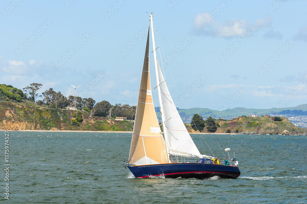 Sailboat gliding on scenic San Francisco Bay with hills and bright sky. Sailboat gliding on scenic San Francisco Bay with hills and bright sky.