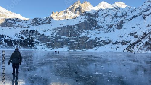 Generated imaWalking on Frozen Lake Oeschinen: Majestic Snow-Capped Peaks in the Swiss Alps photo