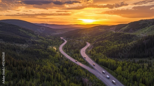 Cargo Route Concept. A winding road through lush mountains under a vibrant sunset sky.