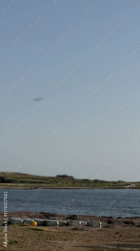 Serene Coastal Vista: Tranquil waters meet a serene shoreline under a clear, expansive sky. The calm atmosphere invites contemplation and relaxation. Serene Coastal Vista: Tranquil waters meet a serene shoreline under a clear, expansive sky. The calm atmosphere invites contemplation and relaxation.