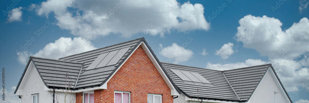 Solar panels installed on home roofs at new housing development Solar panels installed on home roofs at new housing development