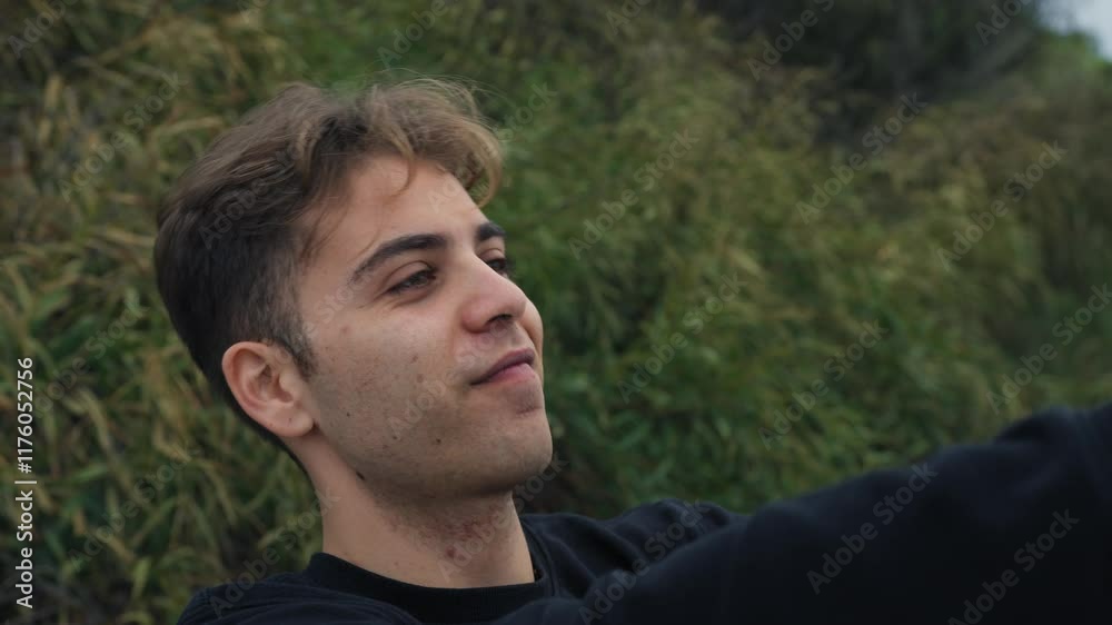 Young Man Takes Vanity Selfies With Smartphone Outside In Nature Young Man Takes Vanity Selfies With Smartphone Outside In Nature