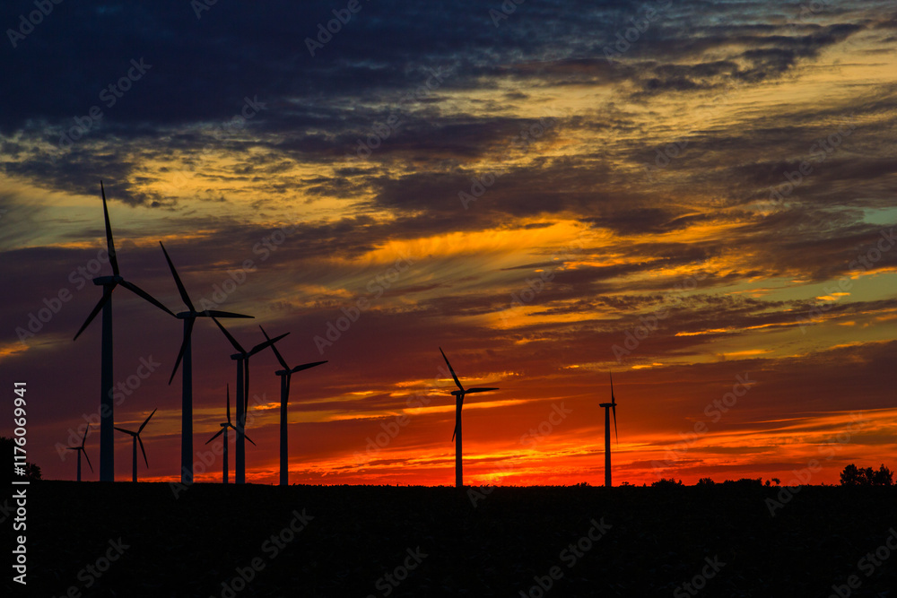Obraz premium wind turbines at sunset