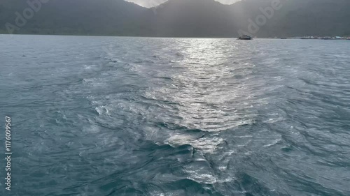 Sea and island view, Look in the distance a big island and a ship approaching, the ship is sailing on the open sea