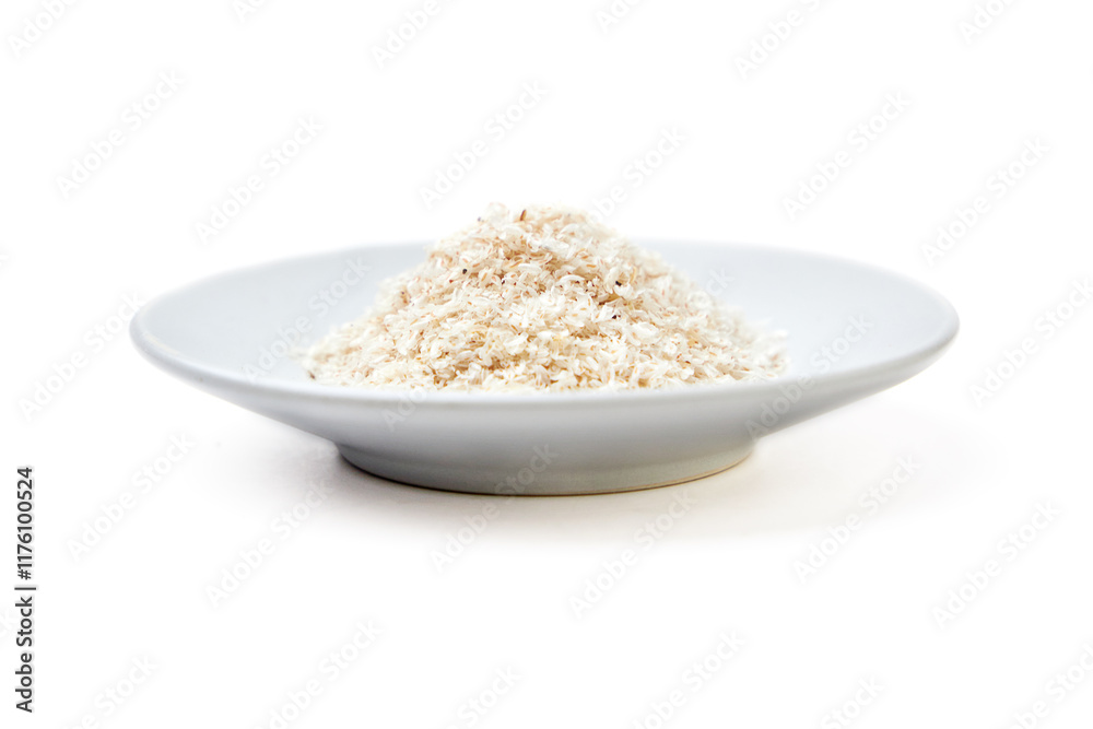 Psyllium husk powder on white plate isolated on white background. Psyllium husk has increasing the volume of feces and amount of water in the intestines, It's used as a laxative to treat constipation. Psyllium husk powder on white plate isolated on white background. Psyllium husk has increasing the volume of feces and amount of water in the intestines, It's used as a laxative to treat constipation.