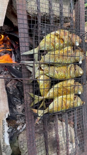 Delicious juicy grilled mackerel. Grilling fish using coconut fiber makes the fish have a distinctive taste, street food festivals, picnics in nature