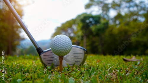 Golf ball and golf club in beautiful golf course at sunset background