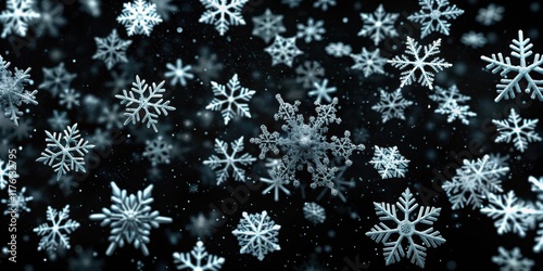 Snowflakes falling in slow motion on a dark black background photo