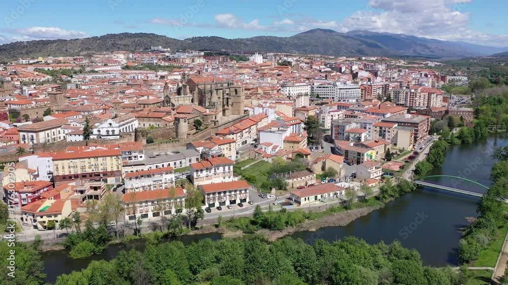 Bird's eye view of residential buildings with tiled roofs, Jerte River and cathedral in Plasencia, Extremadura, Spain. Bird's eye view of residential buildings with tiled roofs, Jerte River and cathedral in Plasencia, Extremadura, Spain.