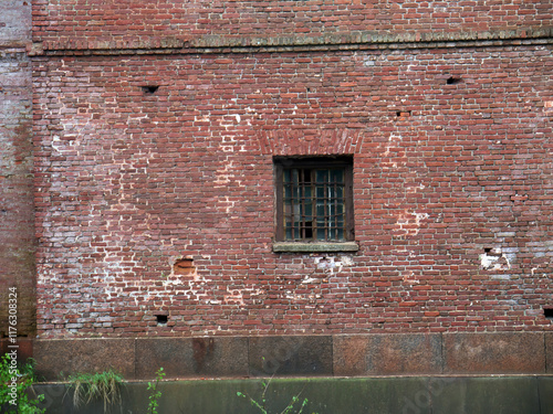 Old prison Red brick wall window with metal bars photo