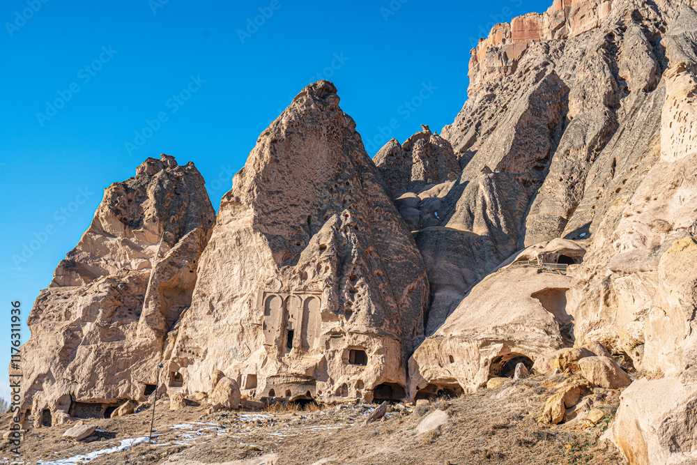 Fototapeta premium The scenic views of Selime Castle which is the largest and most elaborate cave complex in Cappadocia. The multi-level Byzantine settlement includes a kitchen, halls, church, and rooms in Güzelyurt
