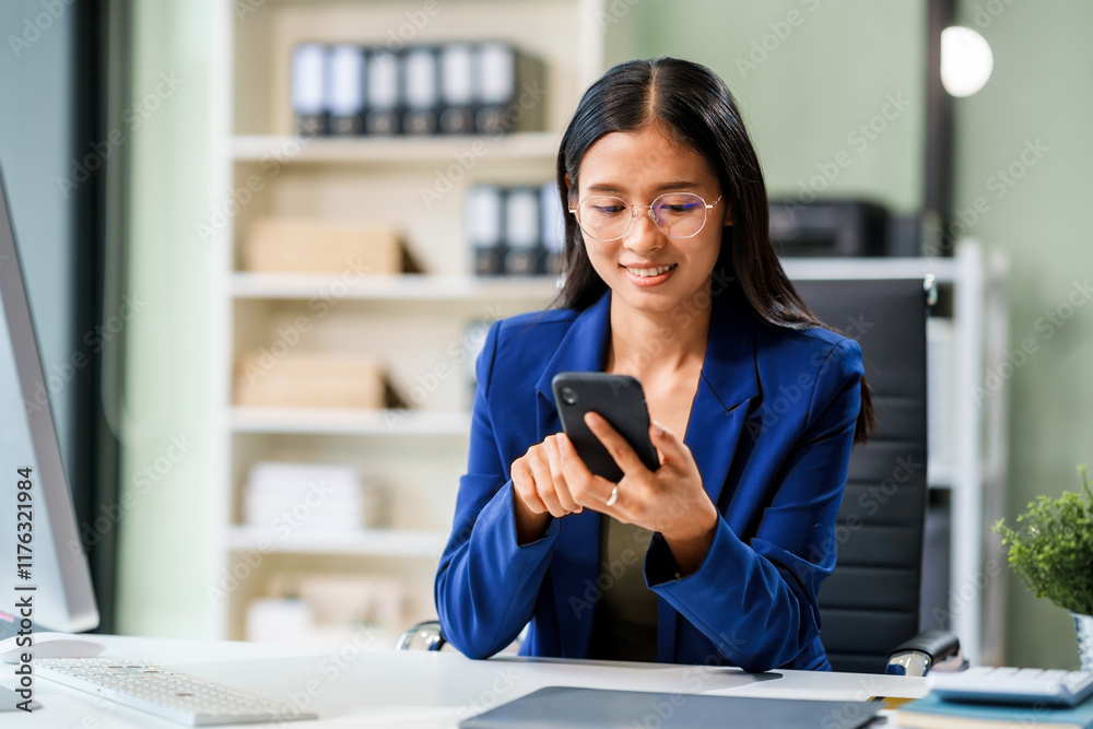 Fototapeta premium A businesswoman sits at her desk in a modern office, working on a laptop. She browses an online banking website, managing finances, analyzing transactions, and making strategic business decisions.