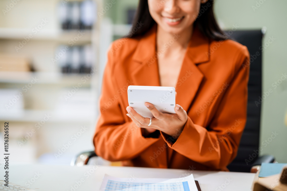 A beautiful Asian businesswoman works at her desk, exuding professionalism and focus.She is deeply engaged in her business tasks,showcasing confidence,dedication,success in a modern work environment A beautiful Asian businesswoman works at her desk, exuding professionalism and focus.She is deeply engaged in her business tasks,showcasing confidence,dedication,success in a modern work environment
