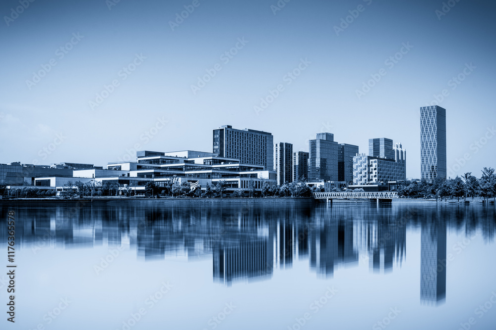 Modern Urban Skyline Reflected on Tranquil Water Surface Modern Urban Skyline Reflected on Tranquil Water Surface