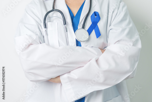 March Colorectal Cancer Awareness month, doctor with dark Blue Ribbon for supporting people living and illness. Healthcare, hope and World cancer day concept photo