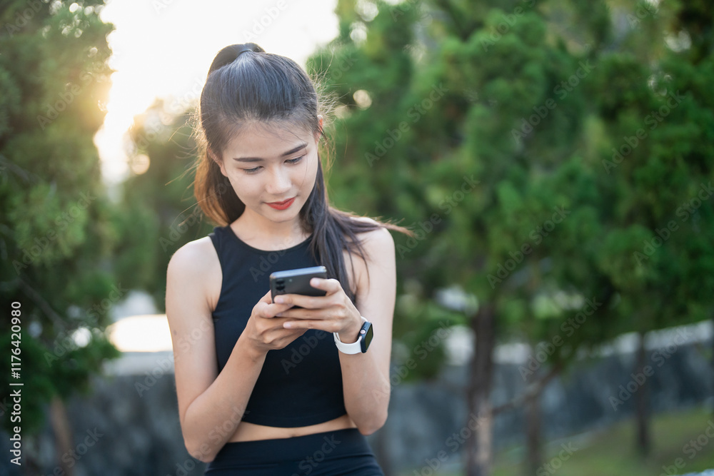 Happy Active healthy asian woman use mobile cell phone exercising with smartphone at urban street outdoors fitness and phone Happy Active healthy asian woman use mobile cell phone exercising with smartphone at urban street outdoors fitness and phone