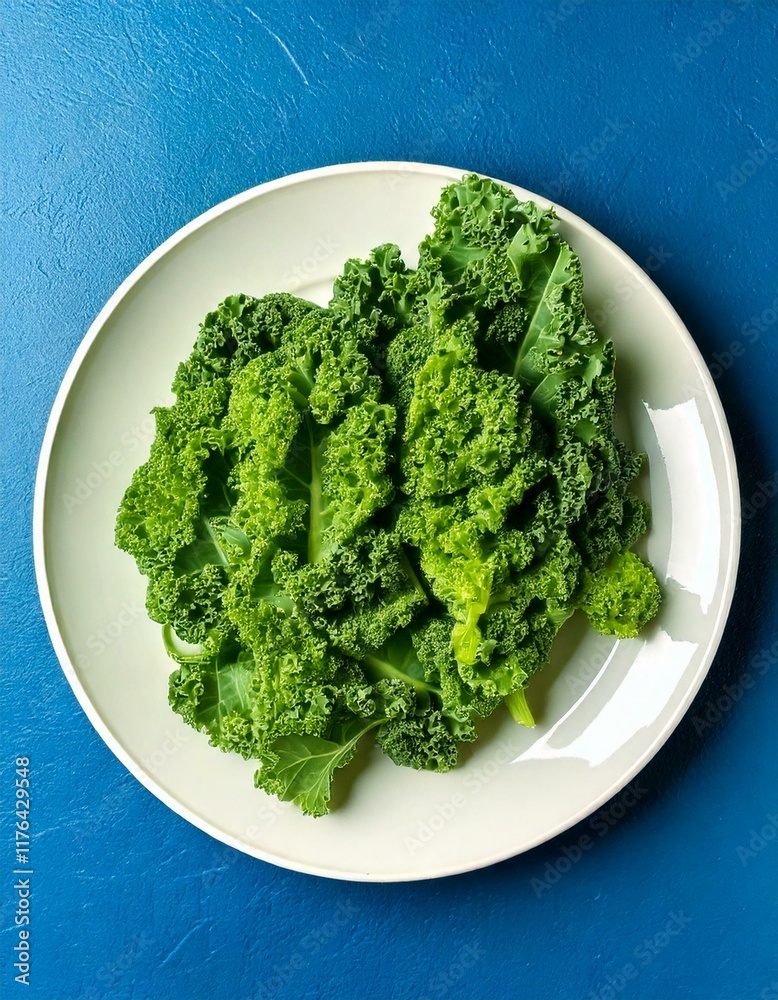Fresh green kale leaves on a white plate and blue background Fresh green kale leaves on a white plate and blue background