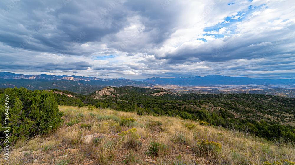 panoramic view of mountain range from hiking trail, showcasing lush greenery and dramatic clouds. landscape evokes sense of adventure and tranquility