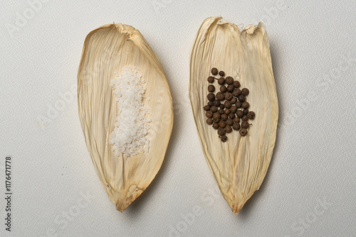 Especias para tamales, sal, pimienta, laurel sobre una hoja seca de maíz, cocina tradicional mexicana.  photo