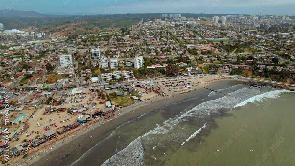 A high pull-back aerial shot of Playa La Boca, Chile, revealing the ENAP Aconcagua division in the left corner, gradually exposing the surrounding town and coastal landscape. A high pull-back aerial shot of Playa La Boca, Chile, revealing the ENAP Aconcagua division in the left corner, gradually exposing the surrounding town and coastal landscape.