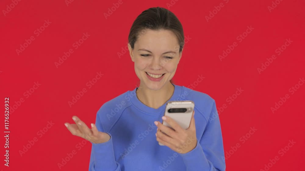 Casual Young Woman Doing Video Chat on Tablet on Red Background Casual Young Woman Doing Video Chat on Tablet on Red Background